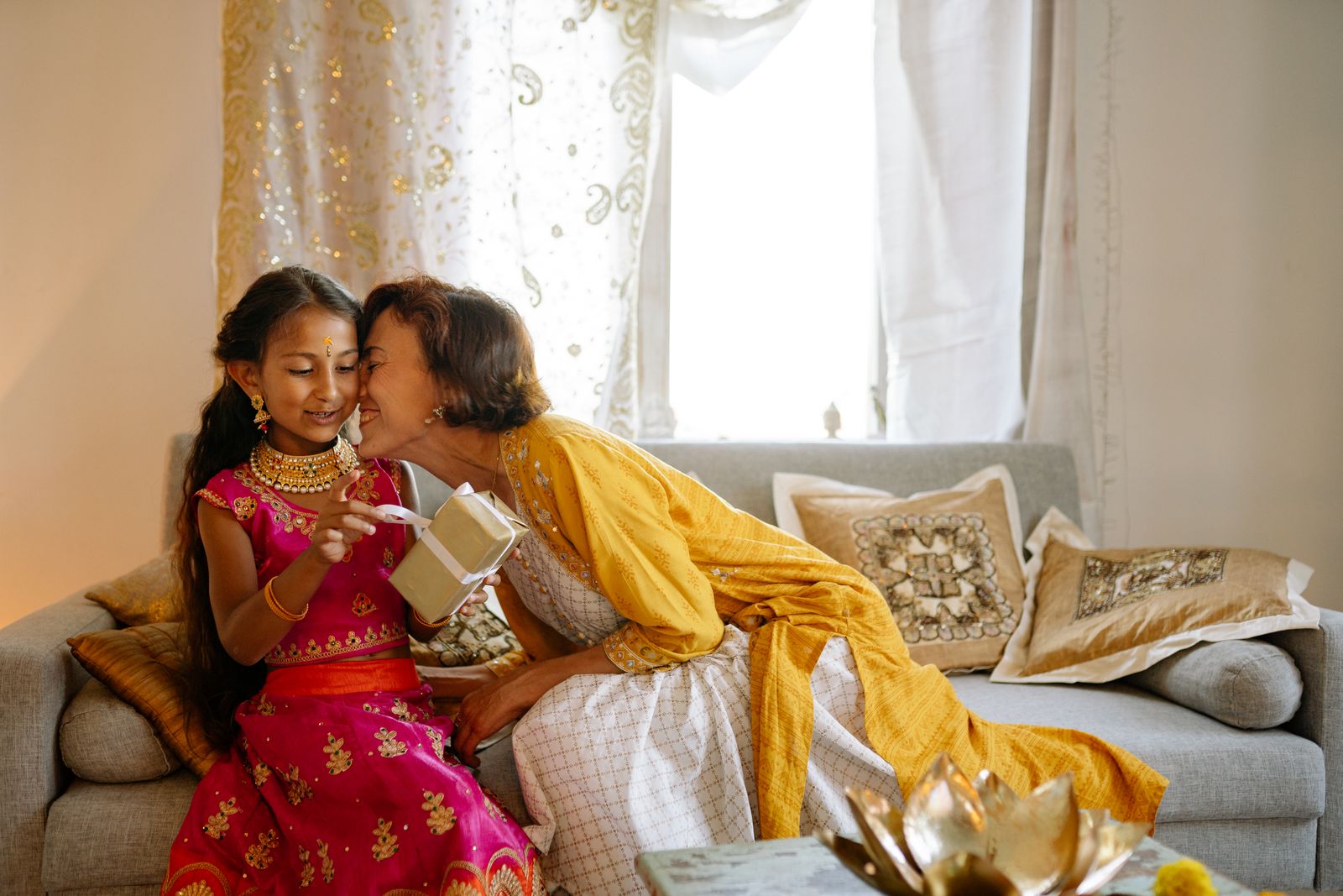 A daughter and her mother sharing a warm moment at home in festive clothes